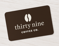 Black gift card with 'thirty nine COFFEE CO.' text on a light wooden surface
