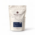 The Nightcap 250g Decaf Coffee Beans — cream coffee bag on white with a soft shadow
